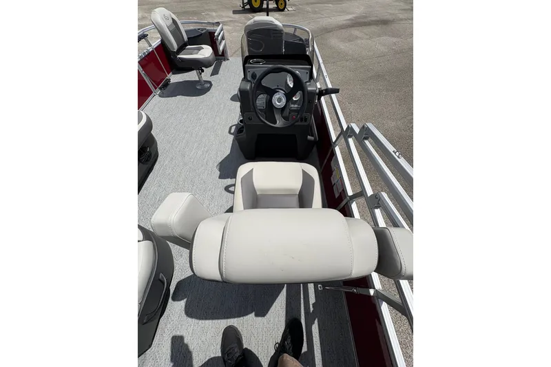 Slide: The Image of 2026 Sun Tracker Bass Buggy 18 DLX interior with steering console and seating. - 12