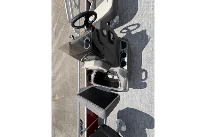 Slide: The Image of 2026 Sun Tracker Bass Buggy 18 DLX boat console with steering wheel and storage compartments. - 14