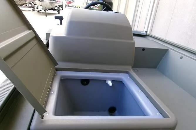 Slide: The Image of 2026 Tracker Grizzly 1648 SC boat interior with open storage compartment. - 7