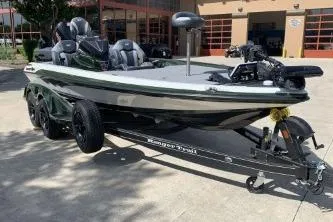 Slide: The Image of 2026 Ranger Z519R fishing boat on trailer, parked outdoors in sunny setting. - 2