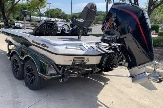Slide: The Image of 2026 Ranger Z519R boat with dual axles and powerful outboard motor in a parking lot. - 6