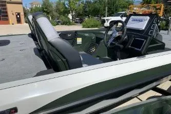 Slide: The Image of 2026 Ranger Z519R boat interior with steering wheel and seating, parked outdoors. - 4