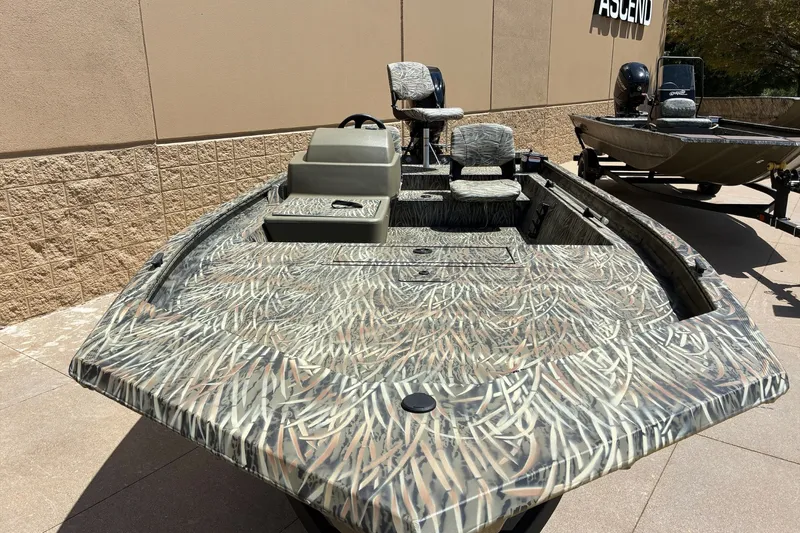 The Image of 2026 Tracker Grizzly 1754 SC boat with camouflage design, displayed outdoors. - 0