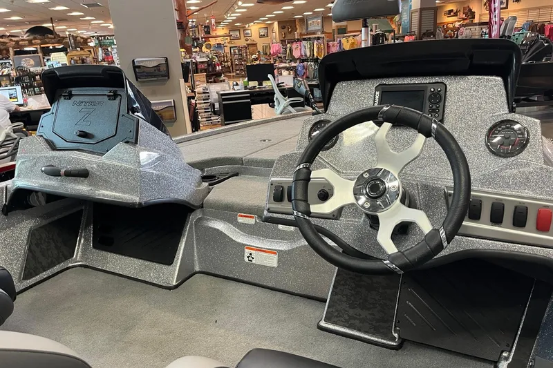 Slide: The Image of Interior of a 2026 Nitro Z19 XL boat with steering wheel and dashboard controls. - 7