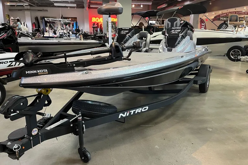 Slide: The Image of 2026 Nitro Z19 XL boat displayed in showroom, featuring Minn Kota Maxxum trolling motor. - 1