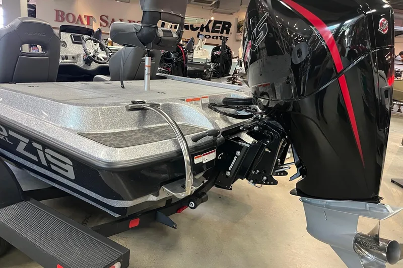 Slide: The Image of 2026 Nitro Z19 XL boat with powerful outboard motor in showroom setting. - 3