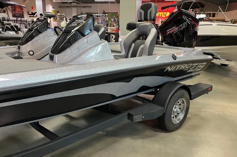 Slide: The Image of 2026 Nitro Z19 XL boat displayed in showroom, featuring sleek design and modern seating. - 2