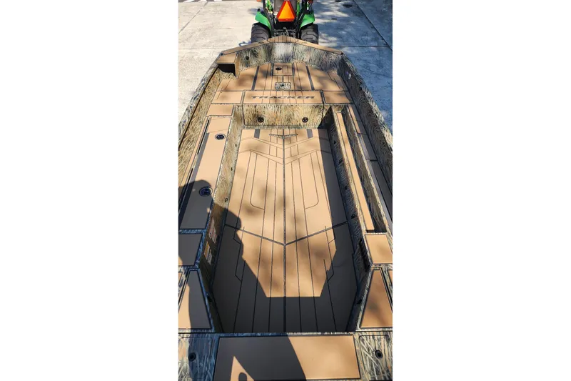 Slide: The Image of 2026 Tracker Grizzly 1756 T Marsh boat interior with camouflage design and spacious layout. - 4