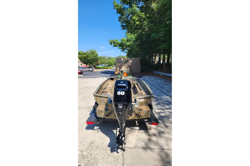 Slide: The Image of 2026 Tracker Grizzly 1756 T Marsh boat with Mercury 60 engine on trailer. - 3