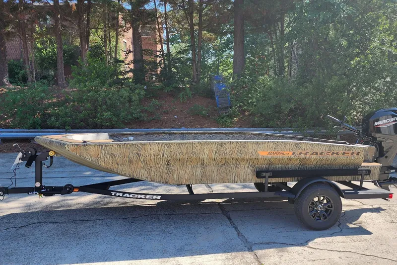 The Image of 2026 Tracker Grizzly 1756 T Marsh boat on trailer, parked outdoors. - 0