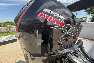 Slide: The Image of Mercury Pro XS engine on a 2026 Tahoe 1950 boat, reflecting sunlight outdoors. - 113