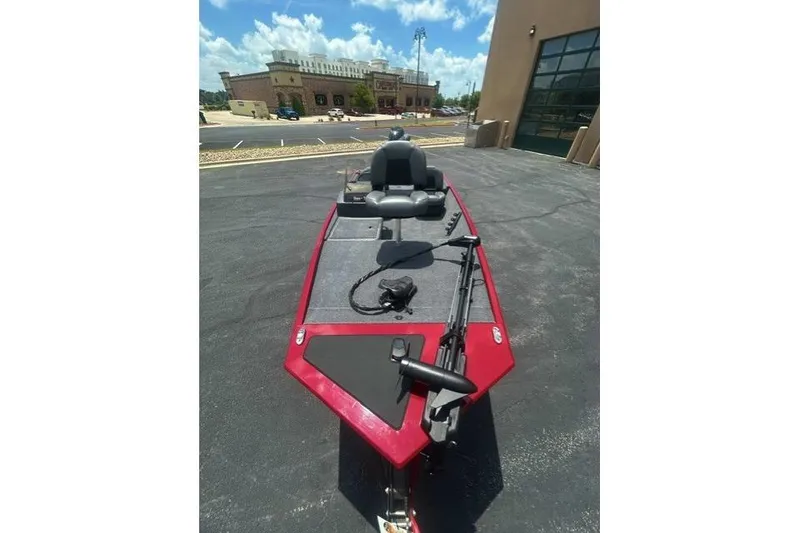 Slide: The Image of 2026 Tracker Bass Tracker Classic XL boat with red trim, parked outdoors. - 4