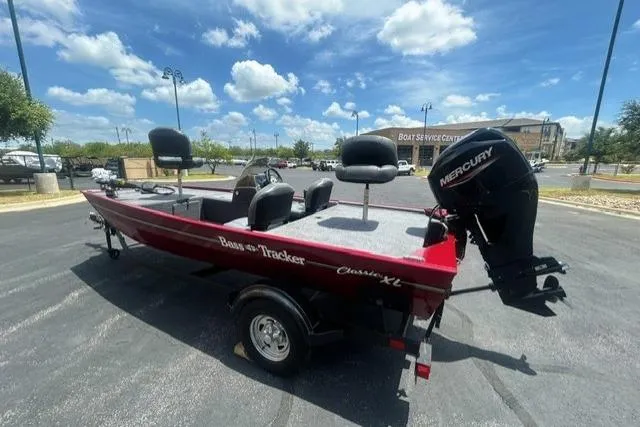 Slide: The Image of 2026 Tracker Bass Tracker Classic XL boat with Mercury engine in parking lot. - 3
