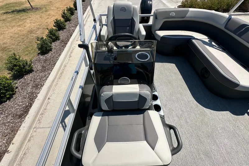 Slide: The Image of 2026 Sun Tracker Bass Buggy 16 XL Select interior with seating and steering console. - 17