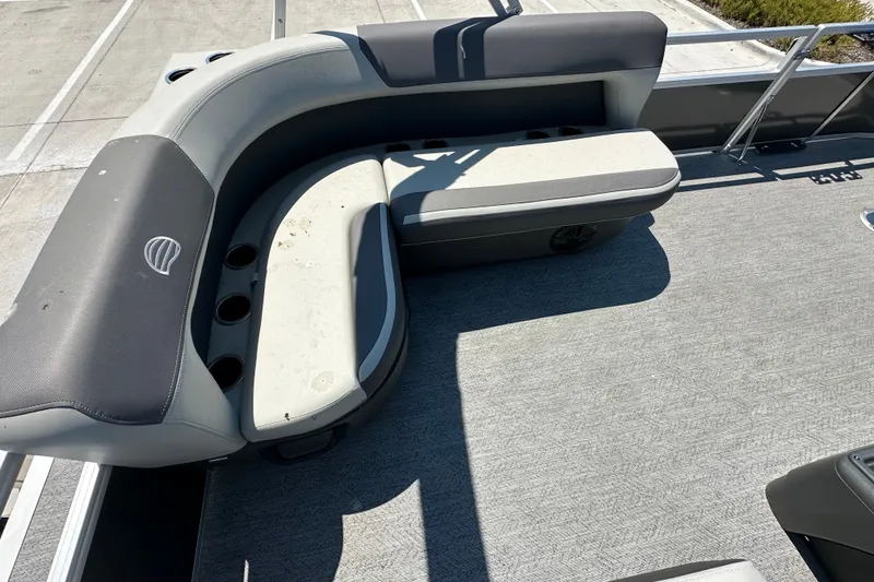 Slide: The Image of 2026 Sun Tracker Bass Buggy 16 XL Select pontoon boat with cushioned seating and cup holders. - 20