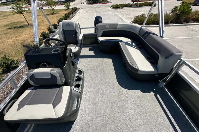 Slide: The Image of 2026 Sun Tracker Bass Buggy 16 XL Select pontoon boat interior with seating and steering console. - 16