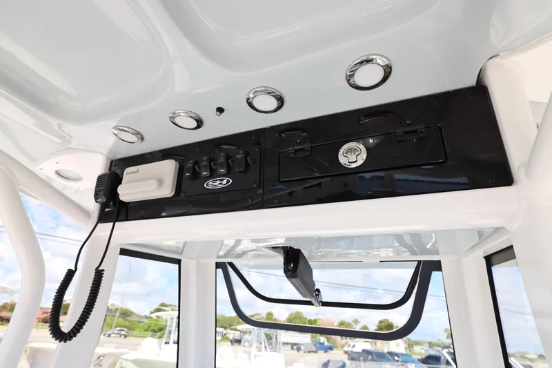 Slide: The Image of 2026 Sea Hunt Ultra 239 SE boat console with radio and control panel. - 12