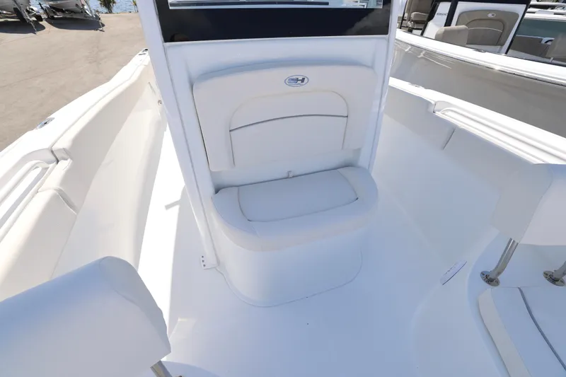 Slide: The Image of 2026 Sea Hunt Ultra 239 SE boat interior with white seating and sleek design. - 17