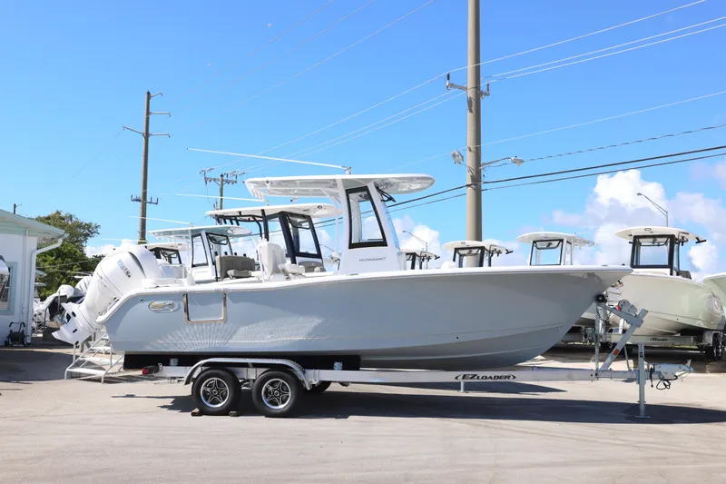 Slide: The Image of 2026 Sea Hunt Ultra 239 SE boat on trailer under clear blue sky. - 19