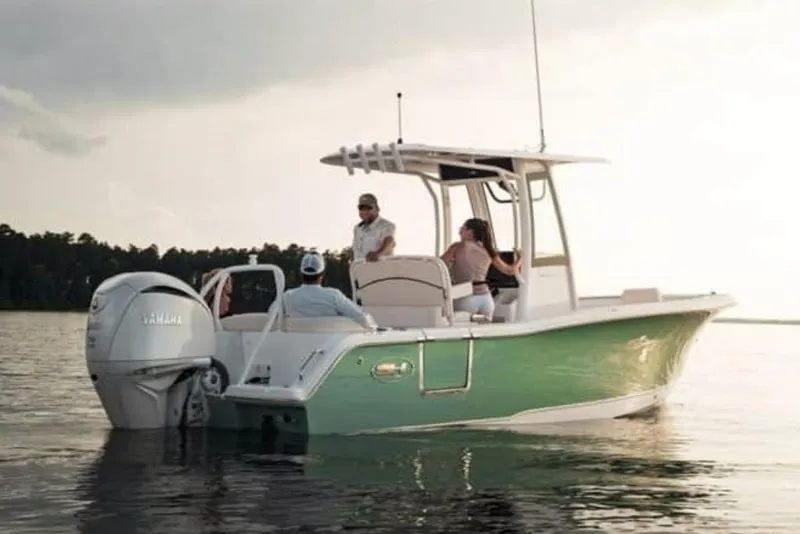 Slide: The Image of Manufacturer Provided Image: 2026 Sea Hunt Ultra 239 SE boat on calm water with people onboard. - 20