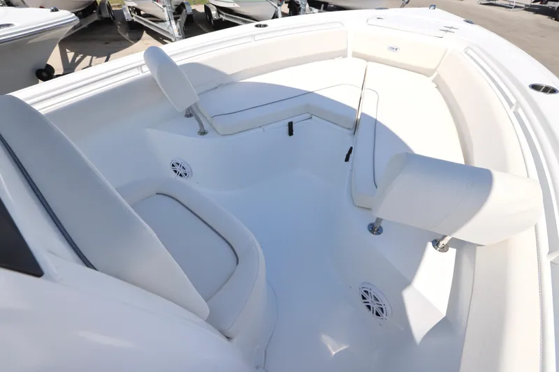 Slide: The Image of 2026 Sea Hunt Ultra 239 SE boat interior with white seating and speakers. - 3