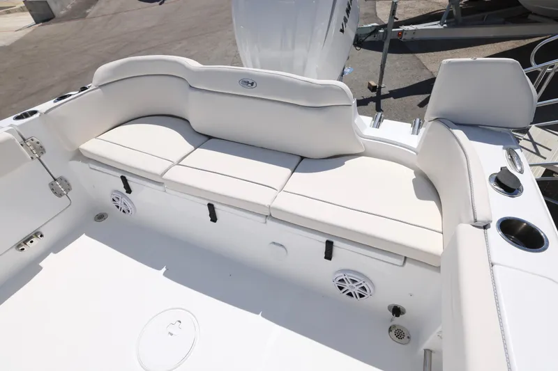 Slide: The Image of 2026 Sea Hunt Ultra 239 SE boat interior with white cushioned seating and cup holders. - 4