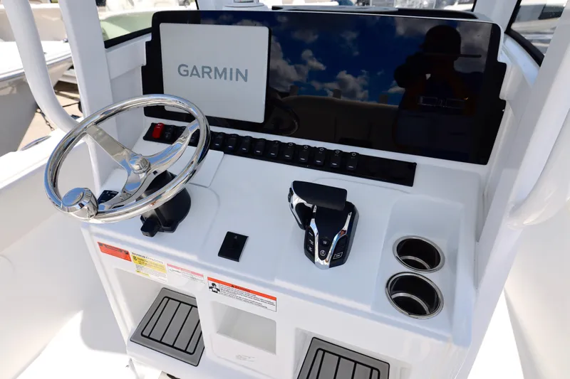 Slide: The Image of 2026 Sea Hunt Ultra 239 SE boat console with Garmin display and steering wheel. - 6