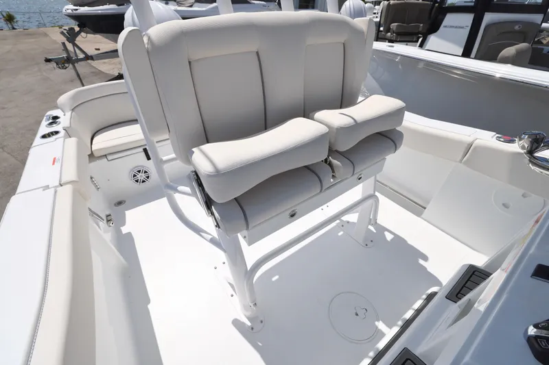 Slide: The Image of 2026 Sea Hunt Ultra 239 SE boat interior with white cushioned seating. - 9