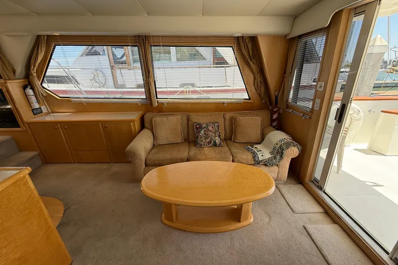 Slide: The Image of Interior of 1997 Navigator Pilothouse yacht with cozy seating and wooden table. - 11
