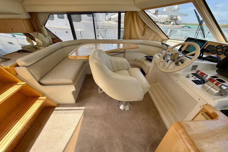 Slide: The Image of 1997 Navigator Pilothouse interior with helm, seating, and wooden accents. - 19