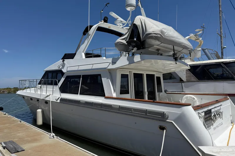 Slide: The Image of 1997 Navigator Pilothouse yacht docked at marina under clear blue sky. - 2