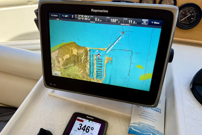 Slide: The Image of Raymarine navigation display on 1997 Navigator Pilothouse, showing coastal map and coordinates. - 22