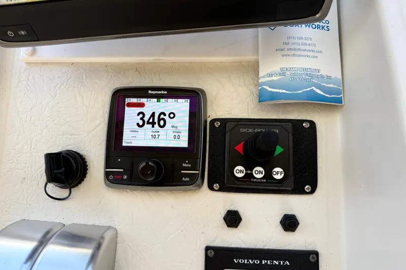 Slide: The Image of Boat navigation controls with Raymarine display, thruster panel, and Volvo Penta branding, Navigator Pilothouse 1997. - 23