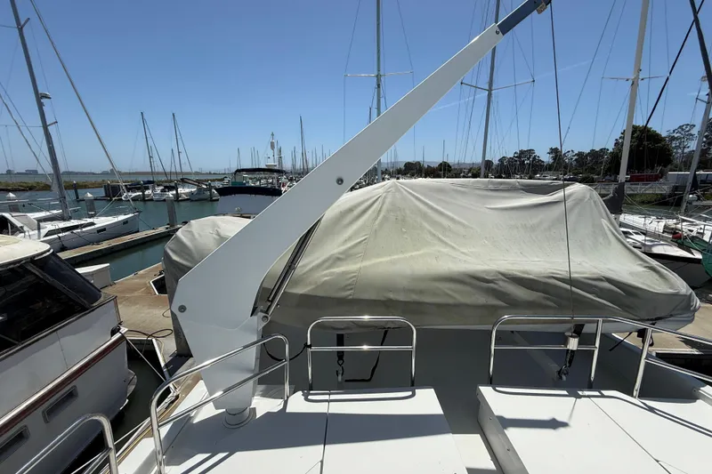 Slide: The Image of 1997 Navigator Pilothouse yacht docked at marina, covered and surrounded by sailboats. - 32