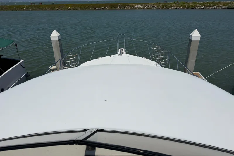 Slide: The Image of 1997 Navigator Pilothouse yacht docked at marina, viewed from the bow. - 33