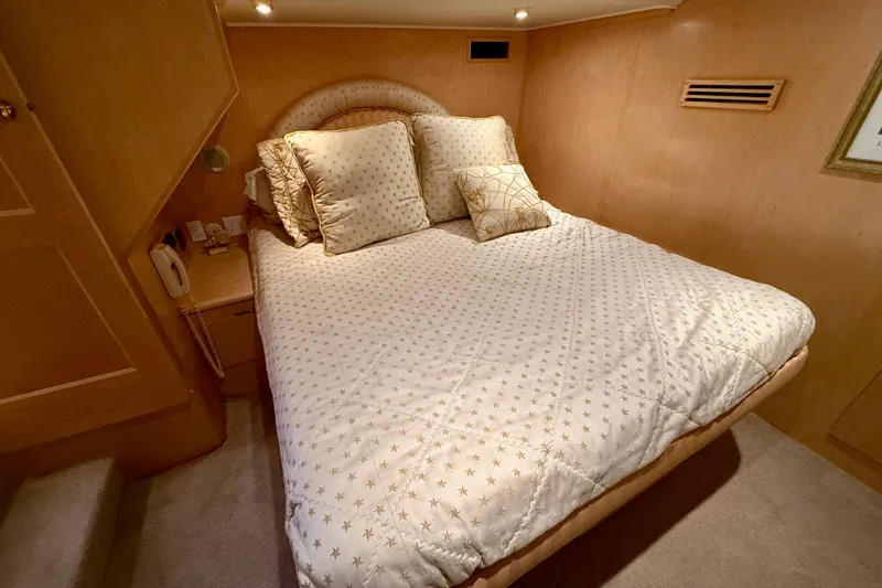 Slide: The Image of Cozy bedroom in 1997 Navigator Pilothouse yacht with star-patterned bedding. - 34