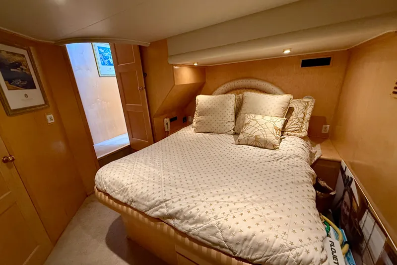 Slide: The Image of Cozy bedroom in 1997 Navigator Pilothouse yacht with plush bedding and warm lighting. - 35