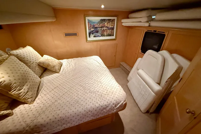 Slide: The Image of Cozy bedroom in 1997 Navigator Pilothouse yacht with plush bedding and framed artwork. - 36