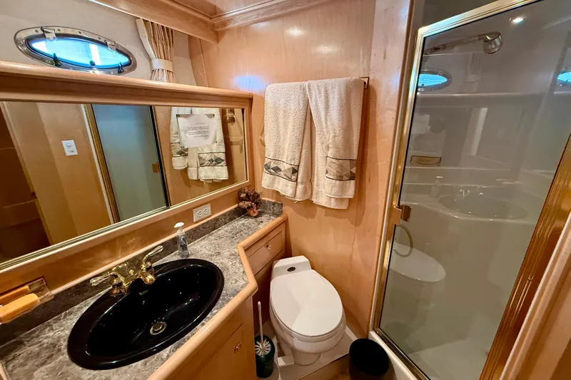 Slide: The Image of Luxurious 1997 Navigator Pilothouse bathroom with black sink, glass shower, and elegant decor. - 37