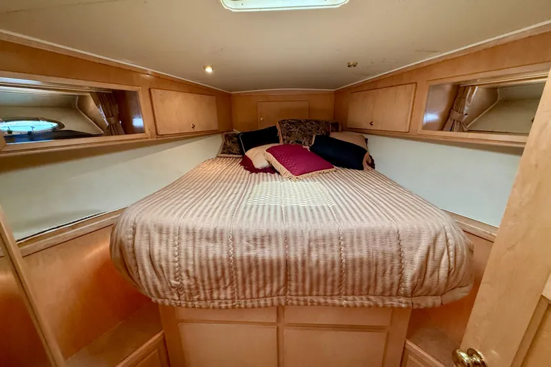 Slide: The Image of Cozy bedroom in 1997 Navigator Pilothouse yacht with plush bedding and wooden cabinetry. - 38