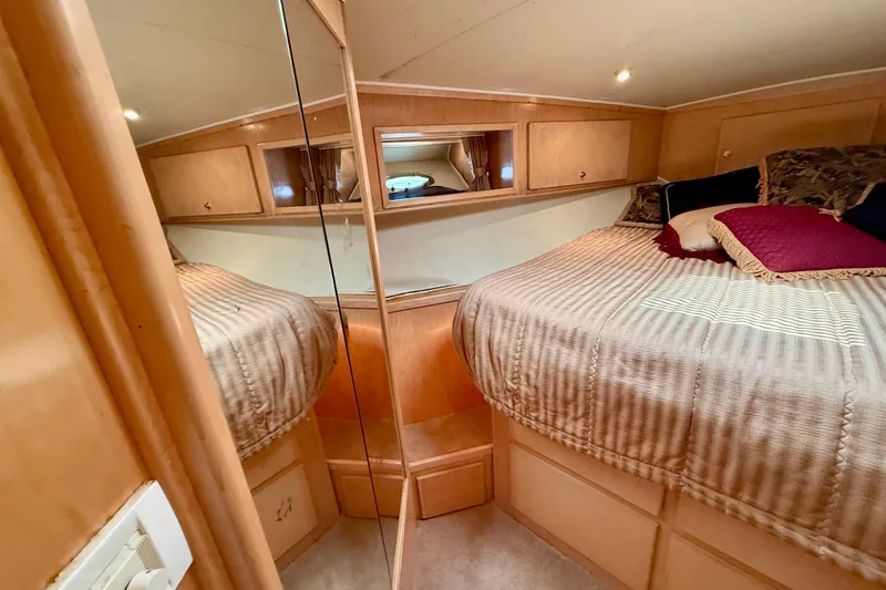 Slide: The Image of 1997 Navigator Pilothouse yacht bedroom with mirrored closet and cozy bedding. - 40