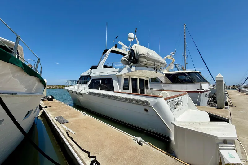 Slide: The Image of 1997 Navigator Pilothouse yacht docked at marina under clear blue sky. - 47