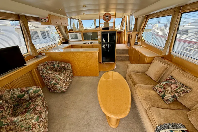 Slide: The Image of Luxurious 1997 Navigator Pilothouse yacht interior with plush seating and elegant wood finishes. - 8