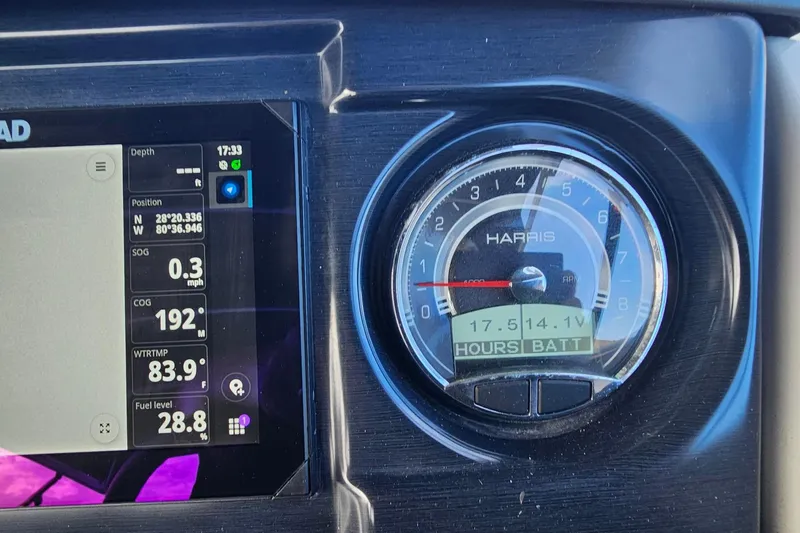 Slide: The Image of Dashboard of a 2024 Harris boat showing navigation and battery information. - 11