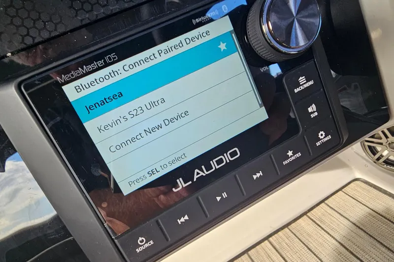 Slide: The Image of JL Audio MediaMaster 105 display on 2024 Harris 325 Solstice, showing Bluetooth connection options. - 28