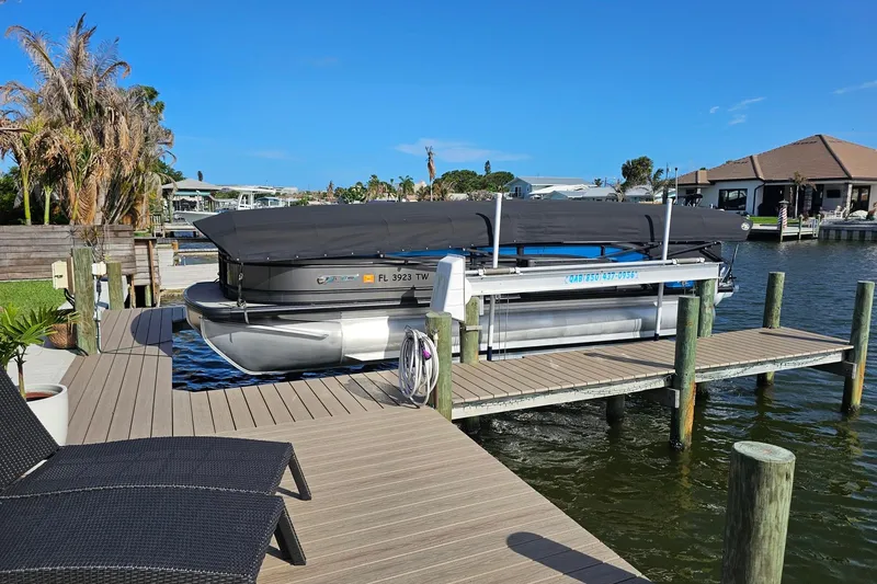 Slide: The Image of 2024 Harris 325 Solstice pontoon boat docked on a sunny waterfront. - 29