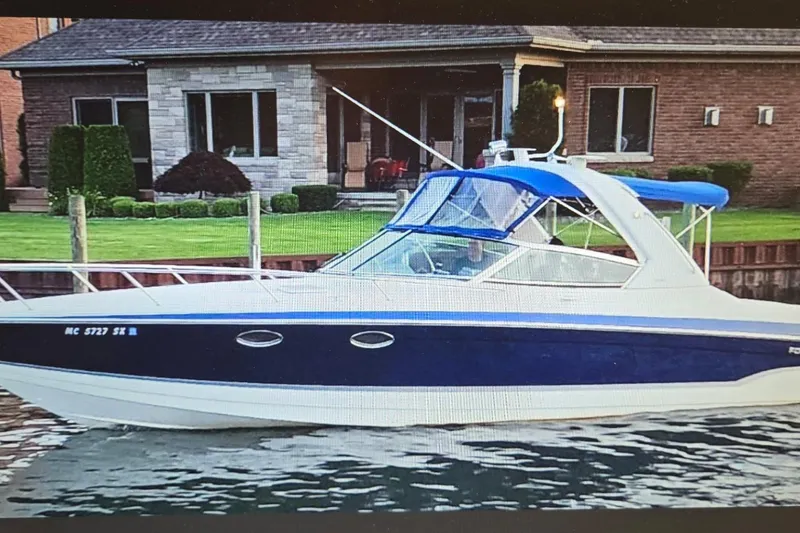 Slide: The Image of 2006 Formula 330 Sun Sport boat docked near a brick house. - 1