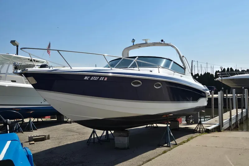 Slide: The Image of 2006 Formula 330 Sun Sport boat on dry dock, marina background. - 11