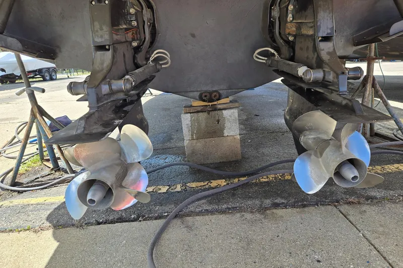 Slide: The Image of Dual propellers of a 2006 Formula 330 Sun Sport boat on a maintenance stand. - 18