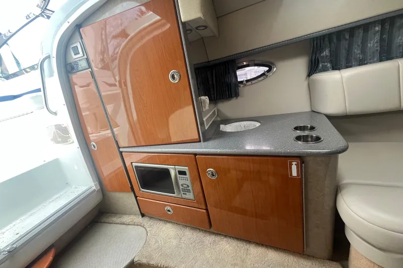 Slide: The Image of Interior of 2006 Formula 330 Sun Sport boat with kitchenette and microwave. - 19
